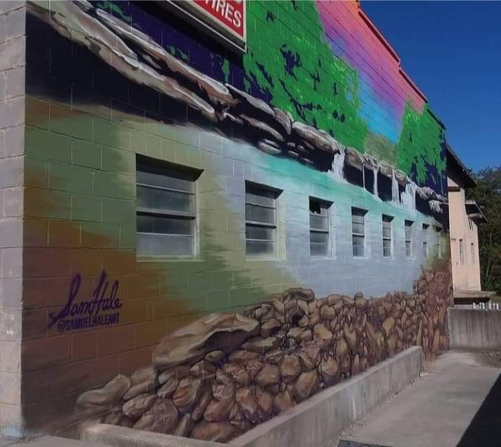 Angled view of the Arkansas landscape and waterfall mural