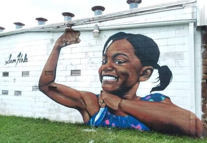 Close view of the smiling child portrait in the Solidarity mural