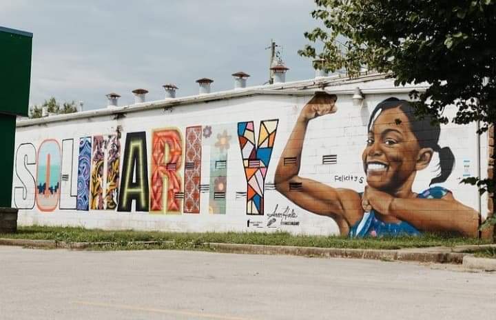 Wide street view of the Solidarity mural by Samuel Hale